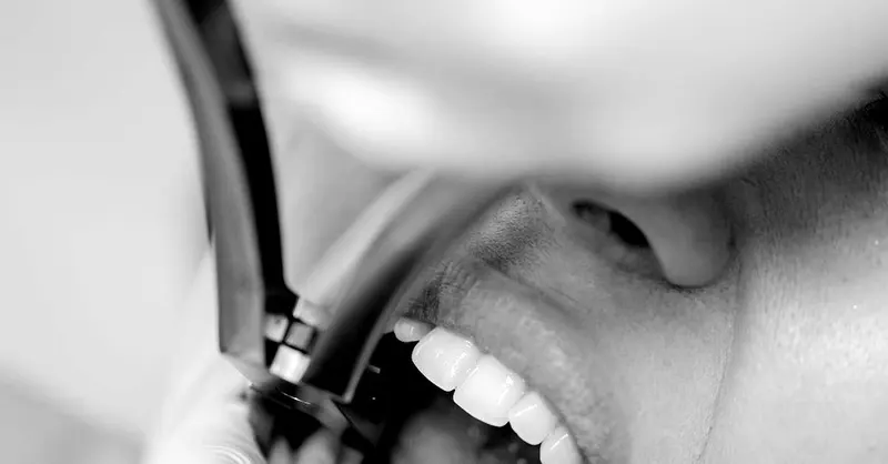 Close-up of a dental cleaning instrument at a patient’s smile