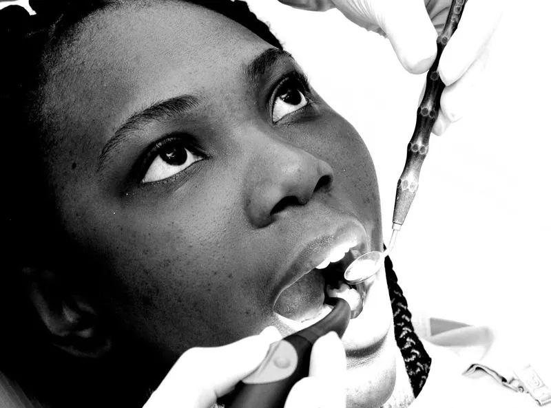 Dentist treating a patient’s tooth with a dental instrument